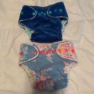 Two orange brand cloth diapers